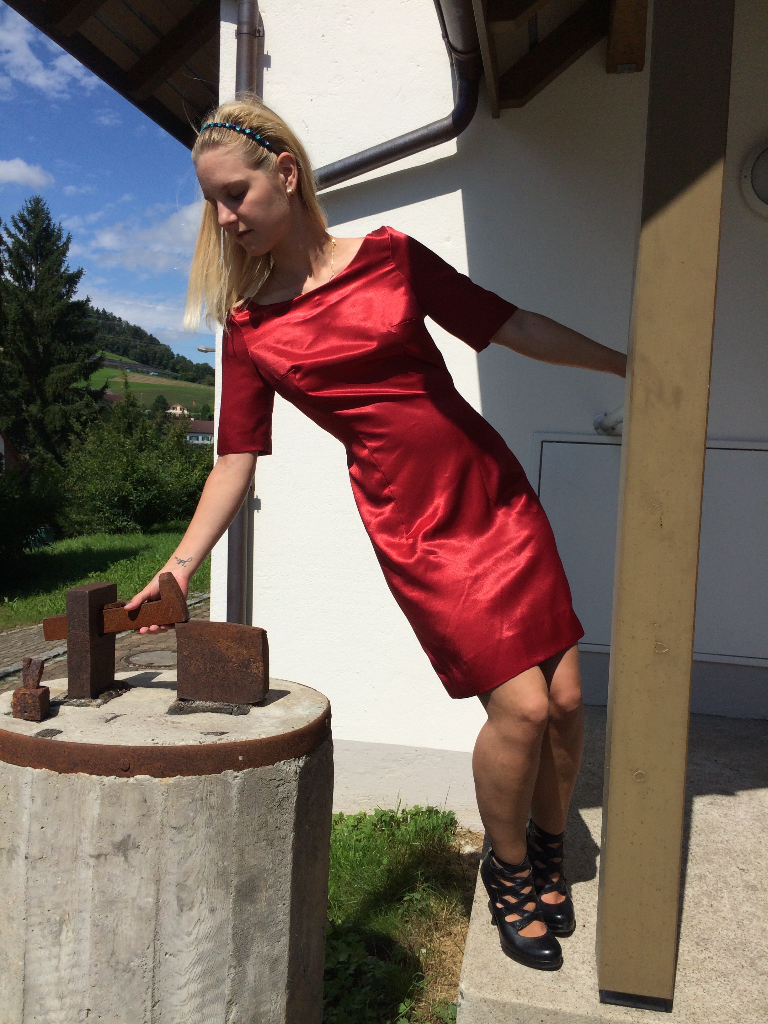 Silky red dress playing with hammer